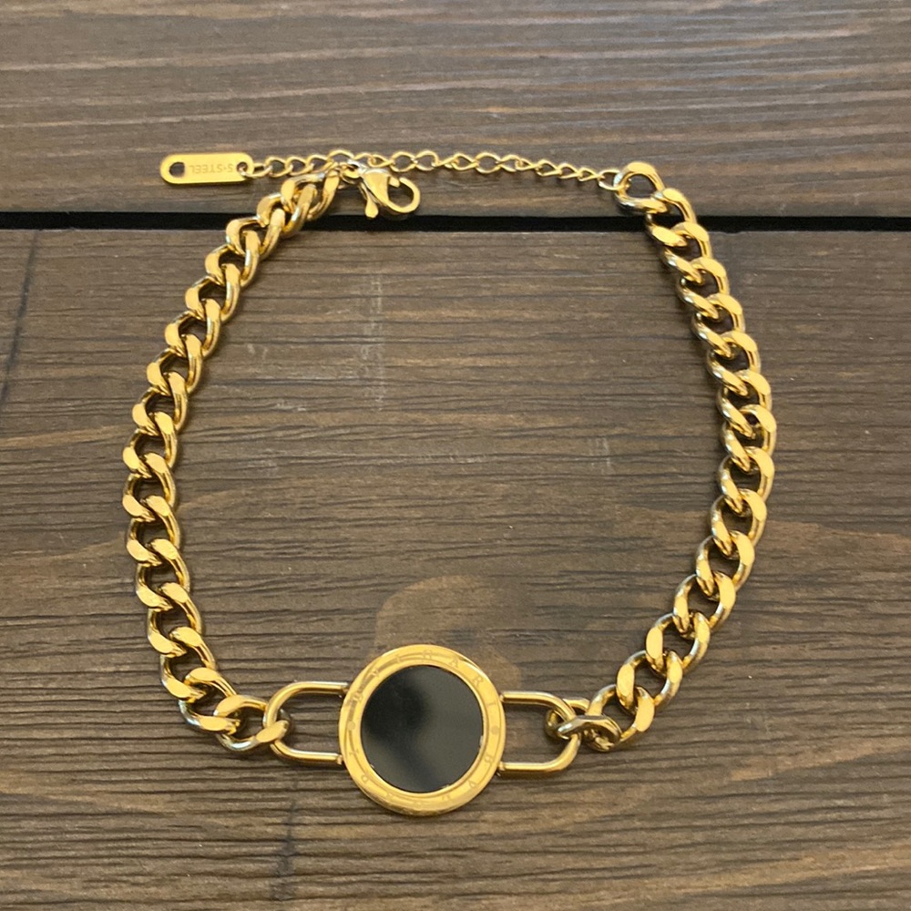 GOLD TITANIUM STEEL BRACELET ACCENTED WITH BLACK CIRCLE AND ROMAN NUMERALS
